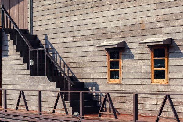 Exterior of hardwood building with window and stairs of wooden resort