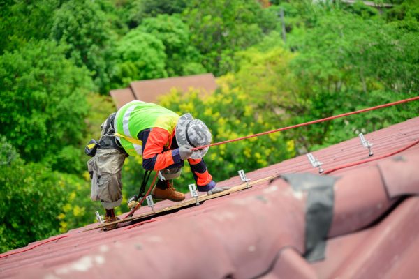 Professional engineer worker installing solar panels system on rooftop, Clean energy sources, Concept of alternative and renewable energy, Environment and technology concept